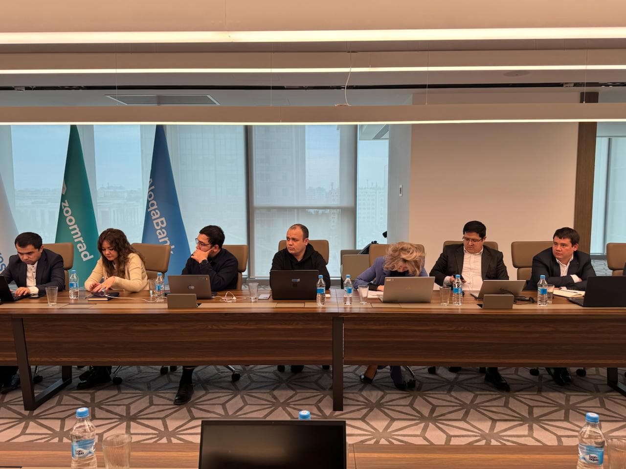 Sprint teams working around the Aloqabank boardroom table